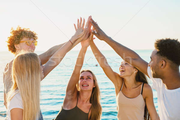 Group of friends having fun on the beach Stock photo © alphaspirit