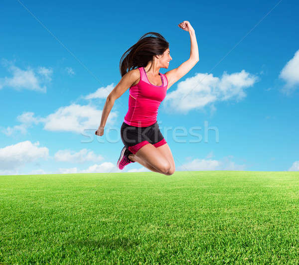 Vital and athletic girl jumps Stock photo © alphaspirit