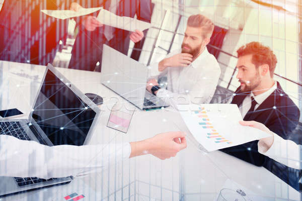 Businessmen that work together in office. Concept of teamwork and partnership. double exposure Stock photo © alphaspirit