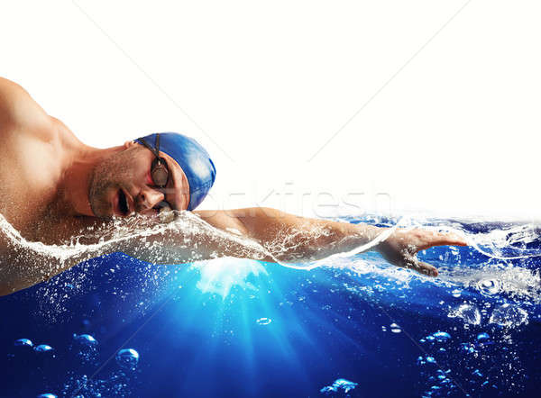 Boy swims in a blue deep water . white space for your text Stock photo © alphaspirit