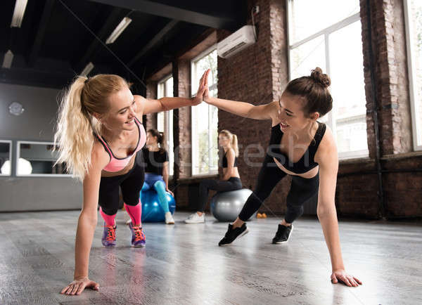 Two friend at the gym doing pushup Stock photo © alphaspirit