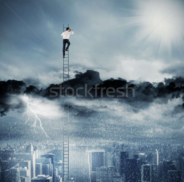 Businessman on a ladder escapes from crisis and looking for a new way Stock photo © alphaspirit