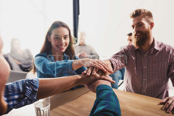 Business people putting their hands together. Concept of teamwork and partnership Stock photo © alphaspirit