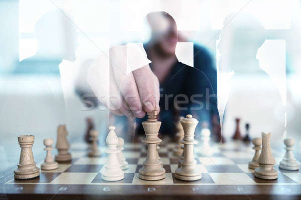 Business tactic with chess game and businessmen that work together in office. Concept of teamwork, p Stock photo © alphaspirit