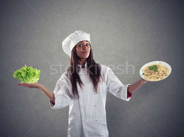 Stock photo: Chef undecided between fresh salad or pasta dish