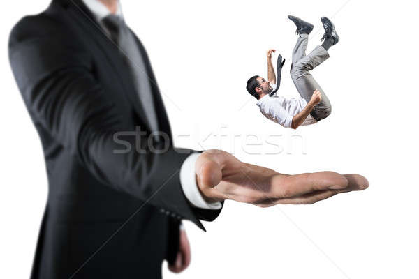 Businessman is saved from a big hand. Concept of business support and assistance Stock photo © alphaspirit