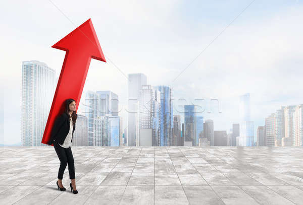 Businesswoman holds a big arrow. Concept of business growth and success Stock photo © alphaspirit