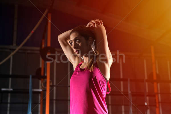 Athletic girl does stretching exercises at the gym Stock photo © alphaspirit