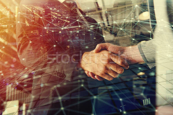 Handshaking business person in office with network effect. concept of teamwork and partnership. doub Stock photo © alphaspirit