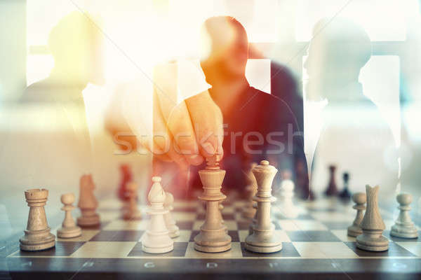 Business tactic with chess game and businessmen that work together in office. Concept of teamwork, p Stock photo © alphaspirit
