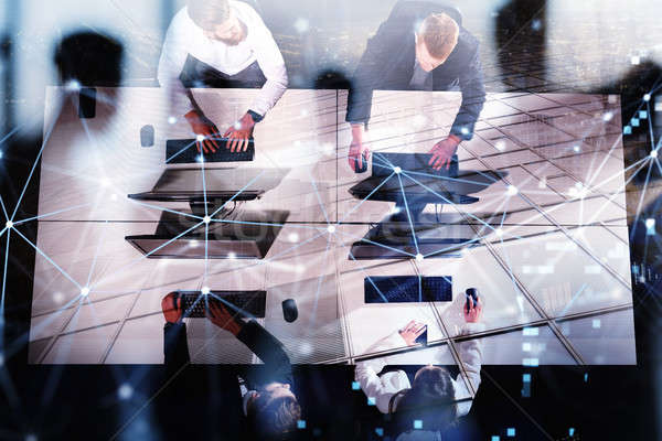 Businessperson in office with network effect. concept of partnership and teamwork. double exposure Stock photo © alphaspirit