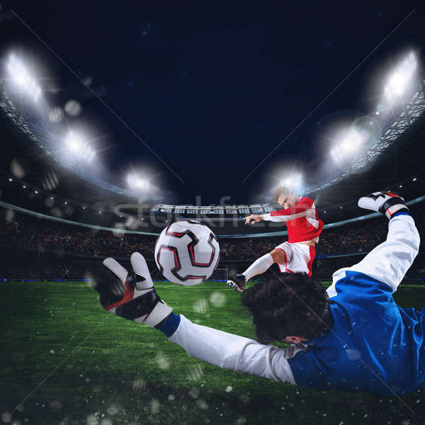 Goalkeeper catches the ball in the stadium Stock photo © alphaspirit
