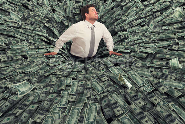Businessman swallowed by a black hole of money. Concept of failure and economic crisis Stock photo © alphaspirit