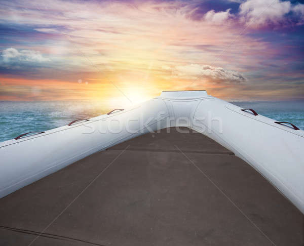 Inflatable boat at the sea during sunset Stock photo © alphaspirit