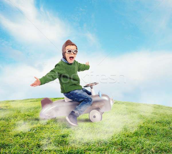 Cheerful boy kid playing at the aviator Stock photo © alphaspirit