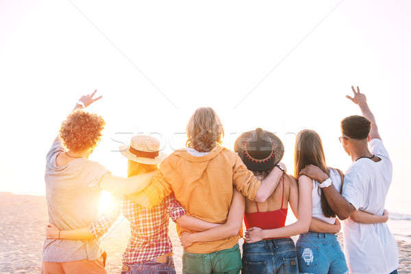 Group of happy friends having fun at ocean beach Stock photo © alphaspirit