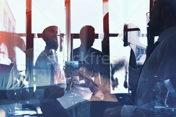 Businessmen that work together in office. Concept of teamwork and partnership. double exposure Stock photo © alphaspirit