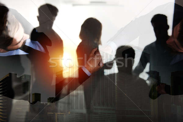 Stock photo: Handshaking business person in office. concept of teamwork and partnership. double exposure