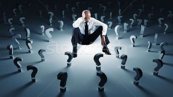Businessman with many question marks. Concept of failure and problem Stock photo © alphaspirit