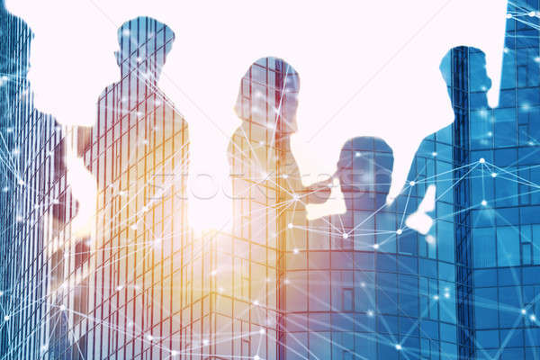 Businessmen that work together in office with network effect. Concept of teamwork and partnership. d Stock photo © alphaspirit