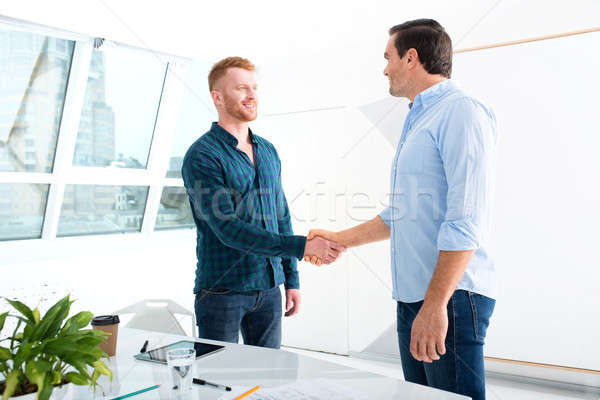 Stock photo: Handshaking business person in office. concept of teamwork and partnership