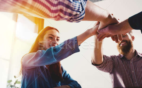 Business people putting their hands together. Concept of teamwork and partnership Stock photo © alphaspirit