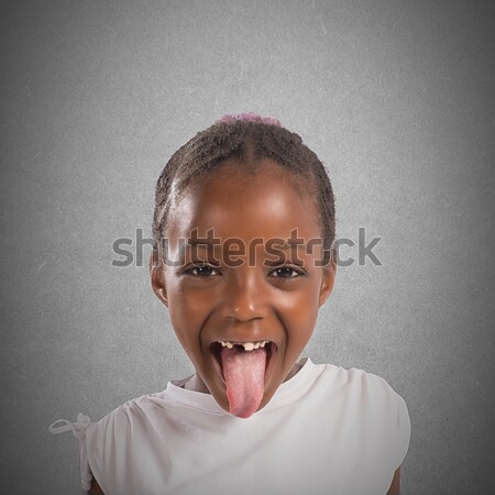 Little girl makes a tongue Stock photo © alphaspirit