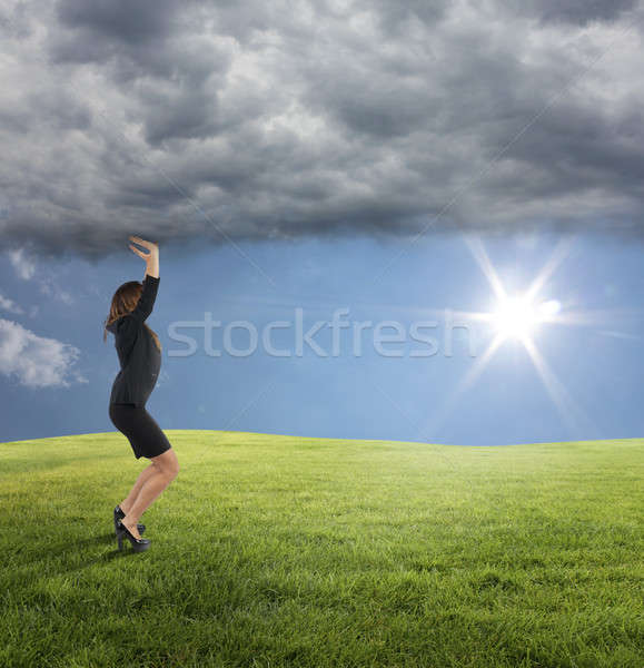 Business woman try to keep the summer instead of bad weather conditions Stock photo © alphaspirit