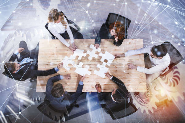 Teamwork of partners. Concept of integration and startup with puzzle pieces and gear overlay. double Stock photo © alphaspirit