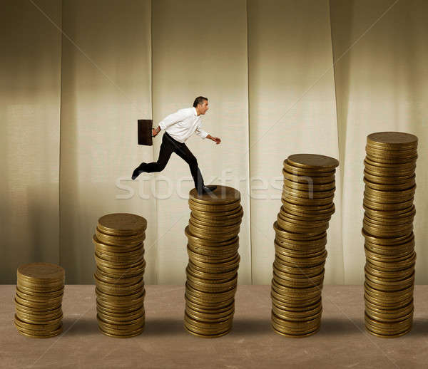 Jumping businessman on money Stock photo © alphaspirit