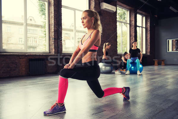 Blonde girl working out at a gym Stock photo © alphaspirit