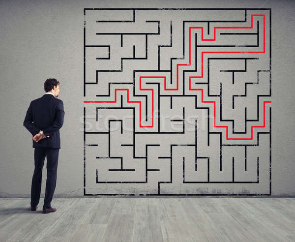 Businessman draws the solution of a labyrinth. Concept of problem solving Stock photo © alphaspirit