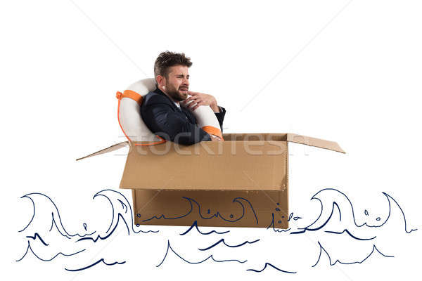 Afraid businessman with cardboard in the ocean Stock photo © alphaspirit