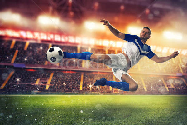 Soccer striker hits the ball with an acrobatic kick Stock photo © alphaspirit