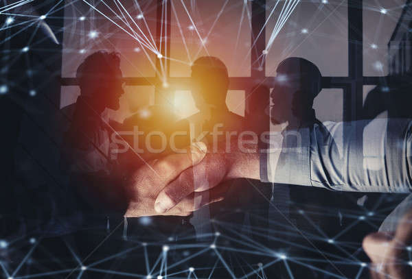 Handshaking business person in office with network effect. concept of teamwork and partnership. doub Stock photo © alphaspirit