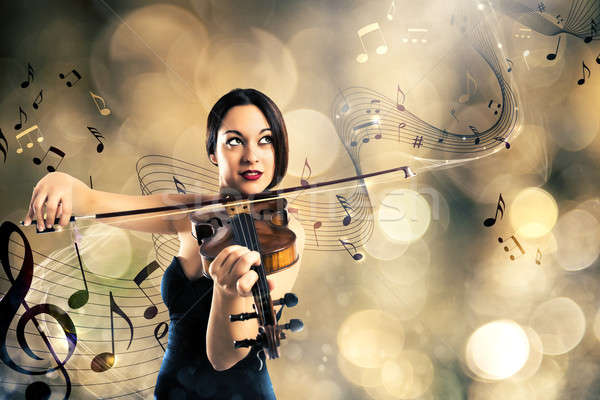 Bájos hegedűművész elegáns nő játszik hegedű Stock fotó © alphaspirit