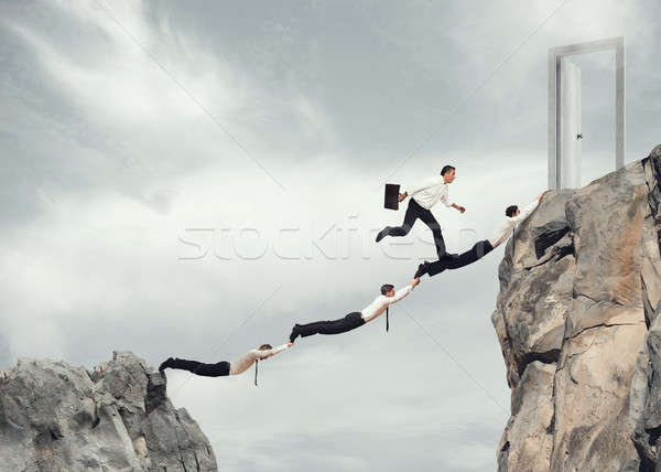 Stock photo: Businessmen working together to reach a door