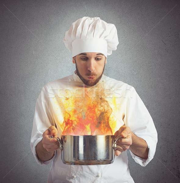 Chef blowing burnt food Stock photo © alphaspirit