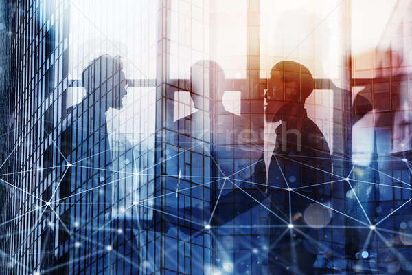 Handshaking business person in office with network effect. concept of teamwork and partnership. doub Stock photo © alphaspirit