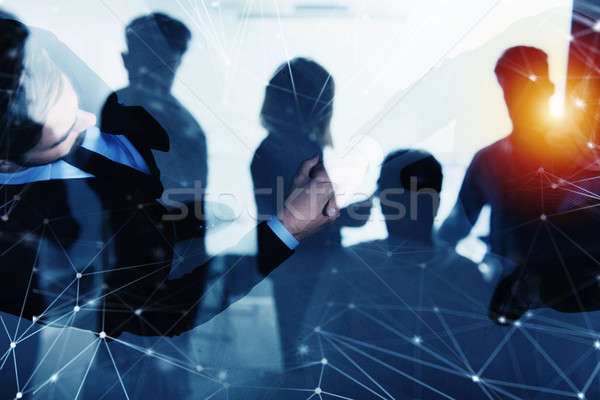 Handshaking business person in office with network effect. concept of teamwork and partnership. doub Stock photo © alphaspirit