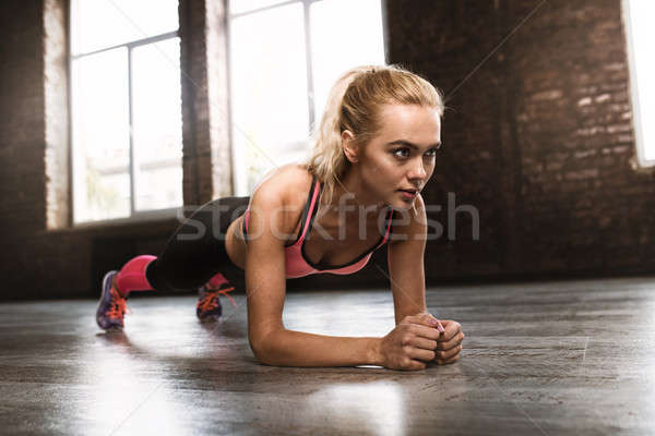 Stock photo: Blonde girl working out at a gym