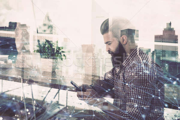 Smartphone of a businessman that shares multimedia with internet connection Stock photo © alphaspirit