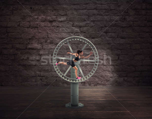 Athletic woman runs in a looping wheel. concept of sport routine Stock photo © alphaspirit