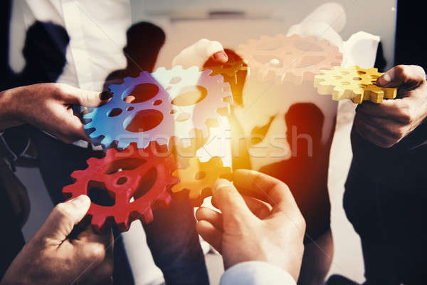 Business team connect pieces of gears. Teamwork, partnership and integration concept. double exposur Stock photo © alphaspirit