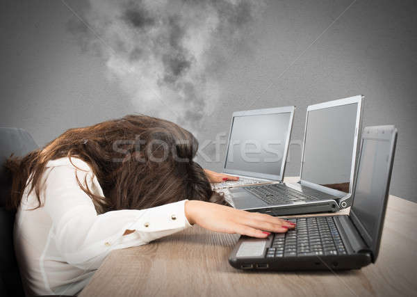 Stressed businesswoman due to overwork Stock photo © alphaspirit