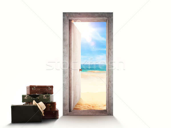 Door on white background leading to the beach with luggage on the floor. Stock photo © alphaspirit