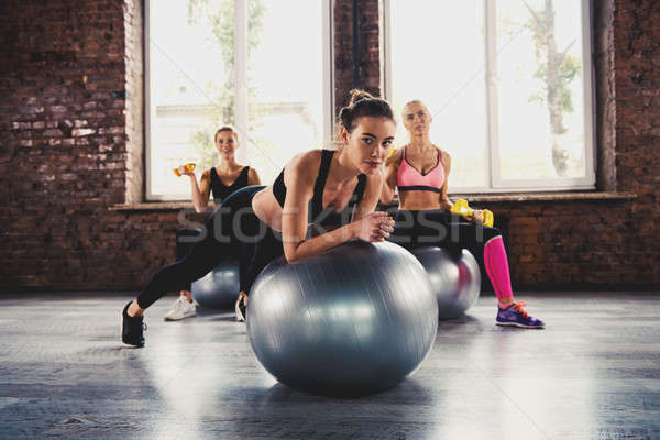 Girls working out at a gym with the gymball Stock photo © alphaspirit