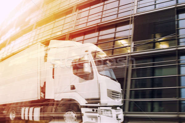 Fast truck reflected on a skyscraper. double exposure Stock photo © alphaspirit