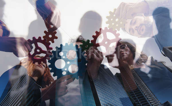 Business team connect pieces of gears. Teamwork, partnership and integration concept. double exposur Stock photo © alphaspirit