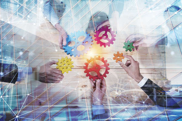 Business team connect pieces of gears. Teamwork, partnership and integration concept with network ef Stock photo © alphaspirit